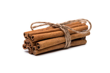 Cinnamon sticks tied with a rope, isolated on white background...
