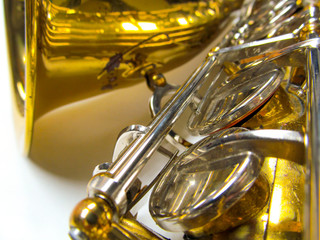 Old golden saxophone close-up.
Beautiful vintage shiny brass jazz musical instrument.