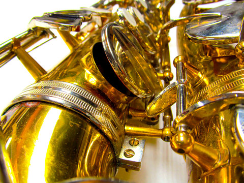 Old golden saxophone close-up.
Beautiful vintage shiny brass jazz musical instrument.
