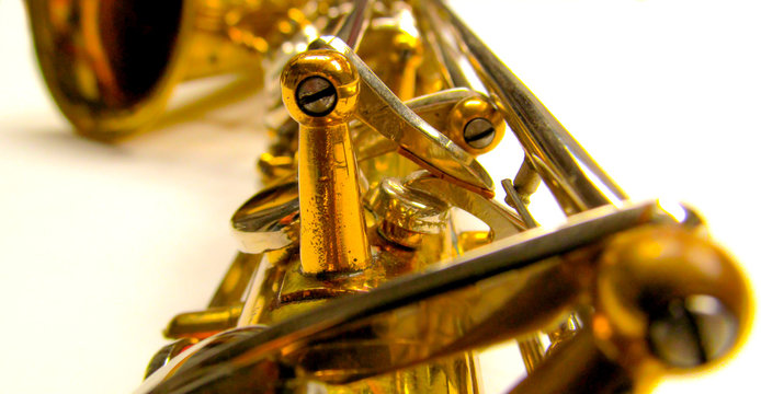 Old golden saxophone close-up.
Beautiful vintage shiny brass jazz musical instrument.