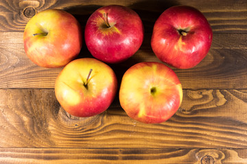 Red apples on wooden table. Top view, copy space