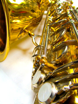 Old golden saxophone close-up.
Beautiful vintage shiny brass jazz musical instrument.