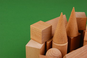 wooden geometric shapes on a green background