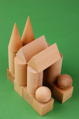 wooden geometric shapes on a green background