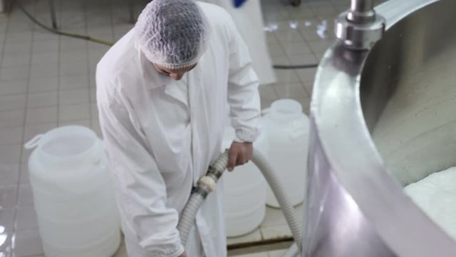  filling the cans with fresh cheese- Cheese factory