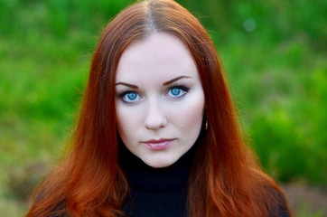 Portrait of a young girl with blue eyes and red hair. Natural make-up
