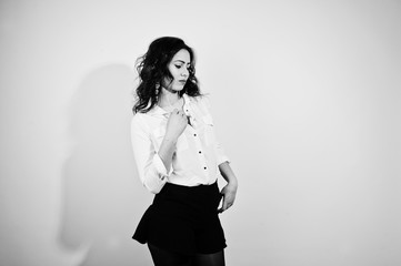 Studio portrait of brunette girl in white blouse on white background.