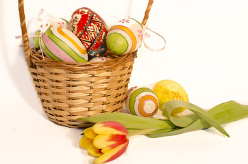 Easter eggs in the basket on white background