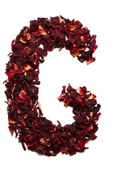 English alphabet. Letter G from dried flowers of hibiscus tea on a white background. Letters for banners, advertisements