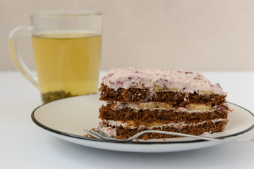 slice of cake with green tea in a cup