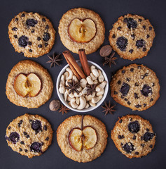 Oatmeal cookies and nuts / Oatmeal cookies with apples, dried fruits and coffee on a dark background top view