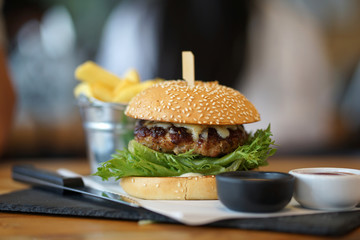 Cheesy pork burger with fresh lettuce serving with french fried