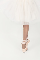 llegs  of the ballerina in pointes and a white dress  isolated on white