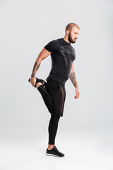 Healthy young sportsman bodybuilder make sports exercises.