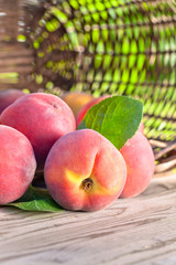 Juicy peaches on wooden table.