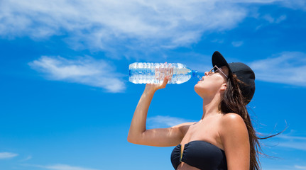 woman with water bottle in summer heat