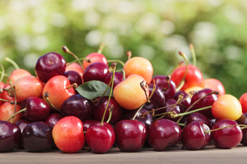Juicy sweet cherries on wooden table.
