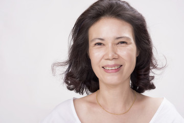 elegant middle aged woman on white background