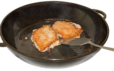 Two fat juicy pork steak in the olive oil in a frying pan