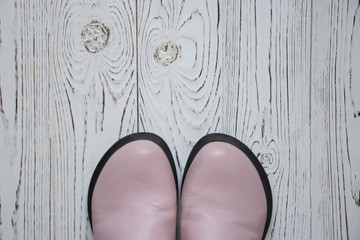 pink boots on wooden background