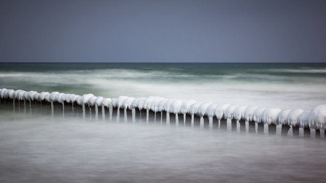 Frozen breakwaters on the popular beach in Chalupy village near Hel, Poland