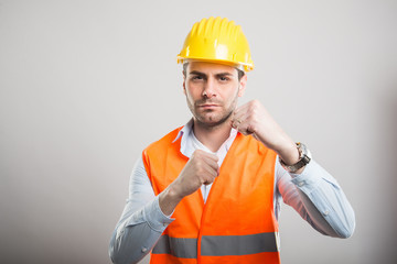 Portrait of attractive architect holding fists like fighting