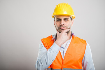 Portrait of attractive architect making thinking gesture