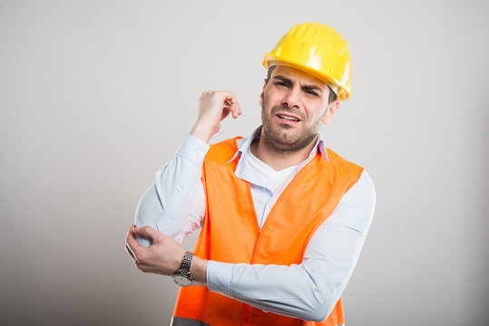 Portrait of attractive architect holding elbow like in pain