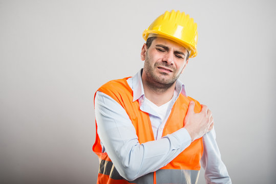 Portrait of young architect holding shoulder like in pain