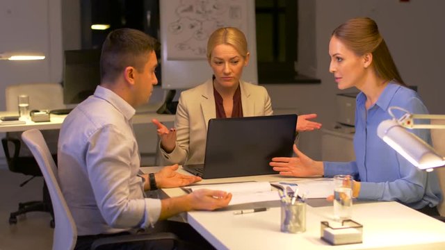 business team with documents argue at night office