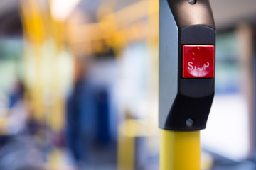 Public transport, inside a bus with stop button and people travelling in the city