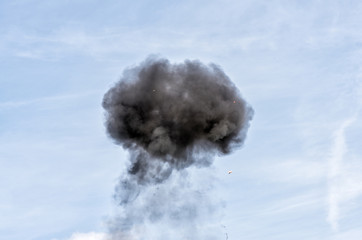 Smoke from explosion in the background of the blue sky