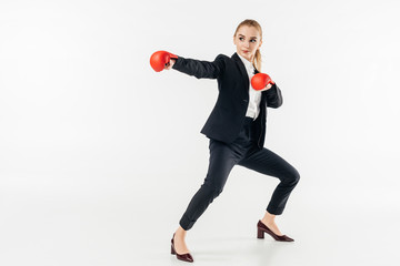 female karate fighter in suit and red gloves isolated on white