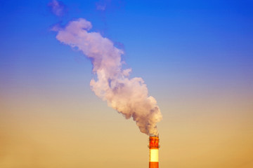 Dense smoke burst from the industrial pipes