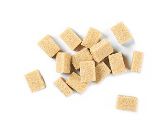 pile brown cane sugar cubes isolated on white background, top view