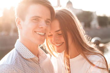 Lovely couple is standing on the street in the city.