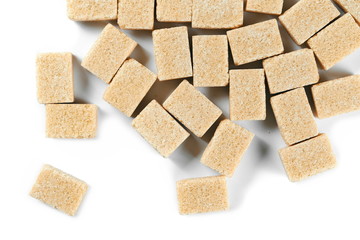 pile brown cane sugar cubes isolated on white background, top view