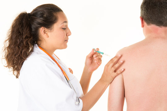 female doctor gives an injection to a male patient or a vaccine