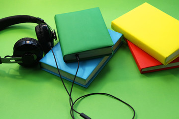 concept of audio books. books in colored covers and headphones on the desktop.