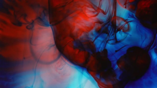 Macro view of colors mixing together creating pattern of tie dye.