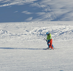 children, boy skiing on slope, do ski lesson with ski instructor who teaches and helps him during sunny day, fresh snow, sunset, winter, Alps, Madonna di Campiglio, Trentino, South Tyrol, Italy