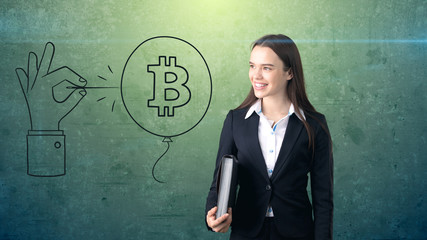 Successful business woman standing near btc logo. She needs to buy or sell Bitcoin. Concept of virtual criptocurrency.