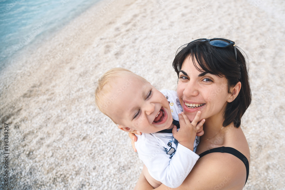 Poster woman holding laughing baby