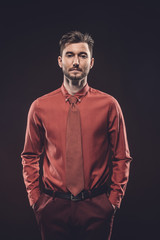 Fototapeta premium Confident man in red shirt isolated on black