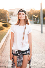 Young woman with white shirt walking on the street