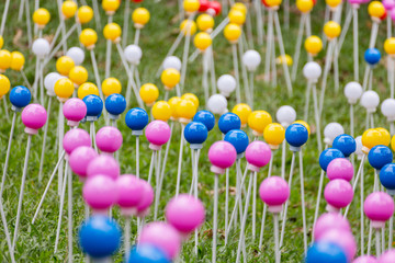 Many multi-colored plastic balls on legs