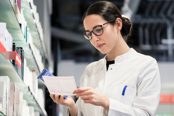 Low-angle portrait of female pharmacist checking a medical prescribtion