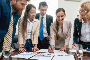 Business expert interpreting charts during an interactive meeting