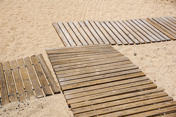 Wooden floor on golden sandy beach