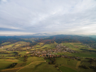 Obraz premium aerial view of beautiful green hills, trees and buildings, Germany